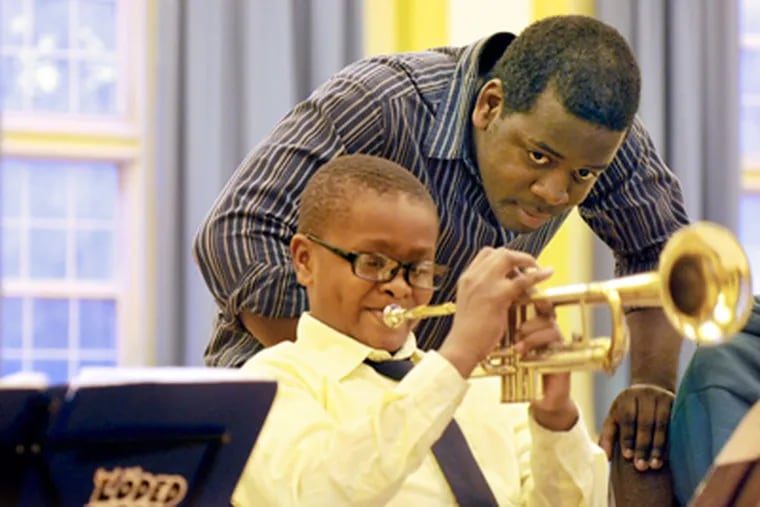 Stanford Thompson, founder and executive director of Play On, Philly!, in November with trumpet players at St. Francis de Sales School in West Philadelphia. (Tom Gralish / Staff Photographer)