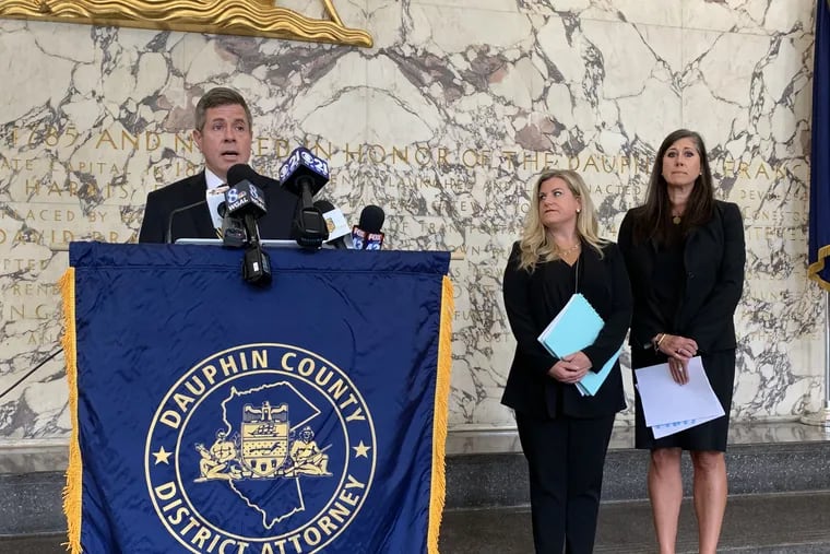 Dauphin County District Attorney Fran Chardo, at the podium, announced at a press conference in Harrisburg on Monday that there will be no criminal charges against former State Rep. Brian Ellis (R., Butler), who was accused of rape. Standing behind him are, from left to right, Pennsylvania Victim Advocate Jennifer Storm and Shea M. Rhodes, director of the Institute to Address Commercial Sexual Exploitation at Villanova University.