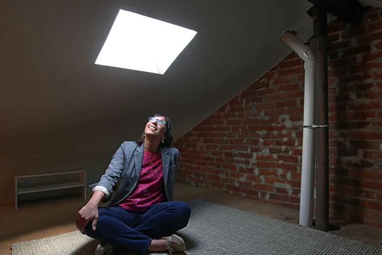 Caroline New under her skylight. Precipitation changed her priorities for the Passyunk Square house.