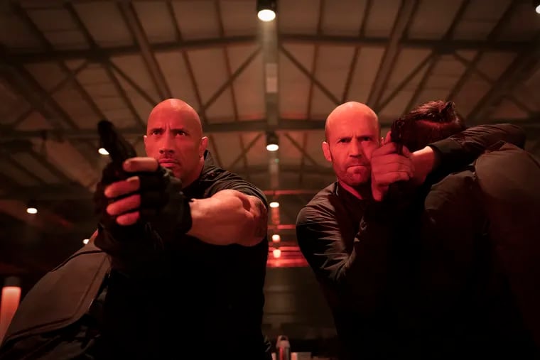 This image released by Universal Pictures shows Dwayne Johnson, left, and Jason Statham in a scene from "Fast & Furious Presents: Hobbs & Shaw." (Daniel Smith/Universal Pictures via AP)