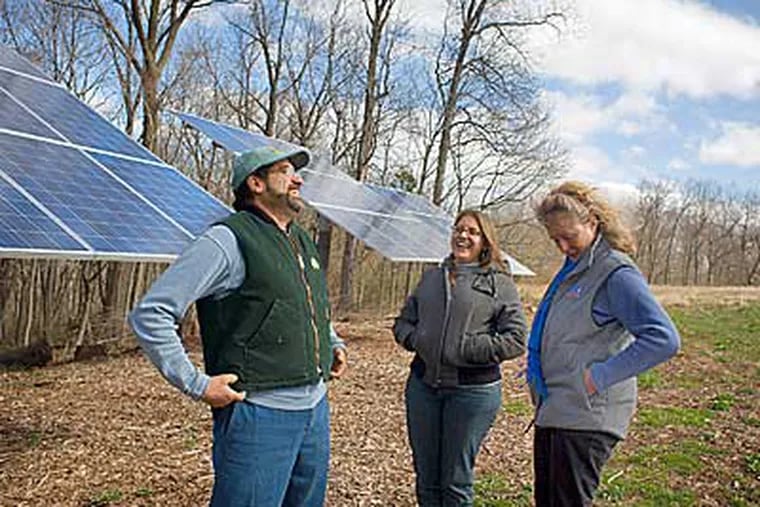 Jon Costanza, president of Sunpower Builders in Collegeville, finally feels like he's a part of an industry about to take off. His daughter Kira, center, serves as the "external relations" manager. With them is Catherine Neil, who owns Heat Shed, another solar power company. (Ed Hille / Staff Photographer)