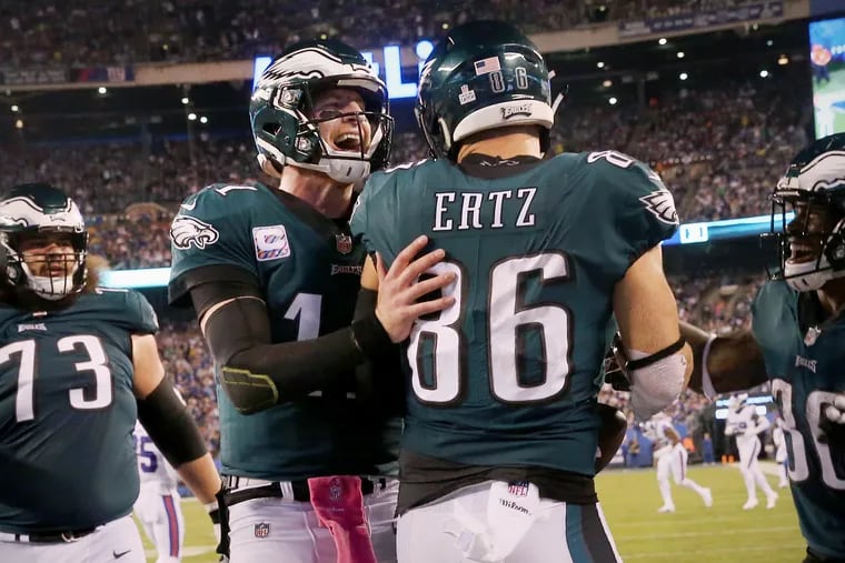 Eagles quarterback Carson Wentz (11) congratulates tight end Zach Ertz (86) after Ertz scored a touchdown in the second quarter of a game against the New York Giants at MetLife Stadium in East Rutherford, N.J., on Thursday, Oct. 11, 2018. The Eagles won 34-13. TIM TAI / Staff Photographer