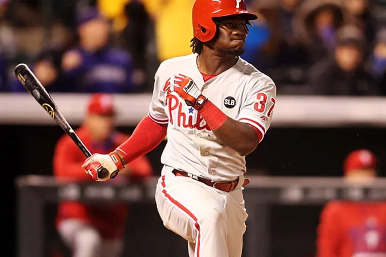 Philadelphia Phillies center fielder Odubel Herrera (37) hits an RBI triple during the sixth inning against the Colorado Rockies at Coors Field. (Chris Humphreys/USA Today)