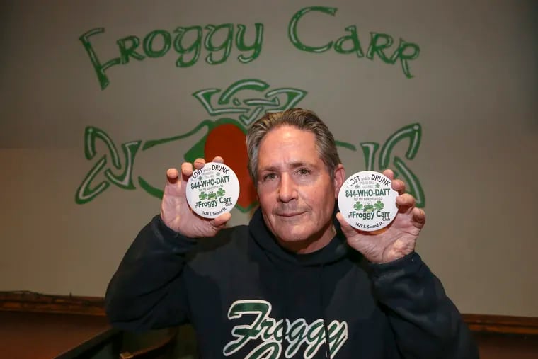 Michael McGrail, who struts with the Froggy Carr Club, holds up the pins he created for this year's Mummers Parade.