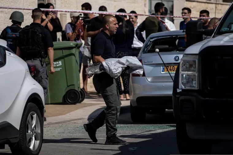 A police sapper carries an exploded rocket from a house it struck in Netivot, Israel, on Tuesday. S senior Islamic Jihad commander was killed earlier in Gaza in a rare targeted attack that threatened to unleash a fierce round of cross-border violence with Palestinian militants.