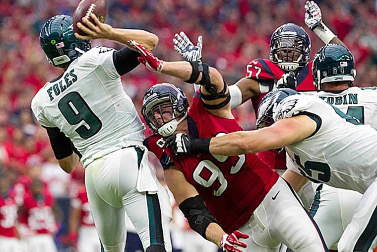 Texans defensive end J.J. Watt pressures Eagles quarterback Nick Foles. (Jason Fochtman/The Courier/AP)