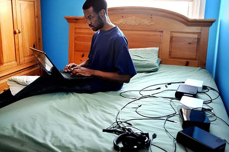 Stanley Joseph, a Penn State grad, desperately wants a job in the computer field. He works on his computer looking for jobs, in his Philadelphia home.  ( SHARON GEKOSKI-KIMMEL / Staff Photographer )