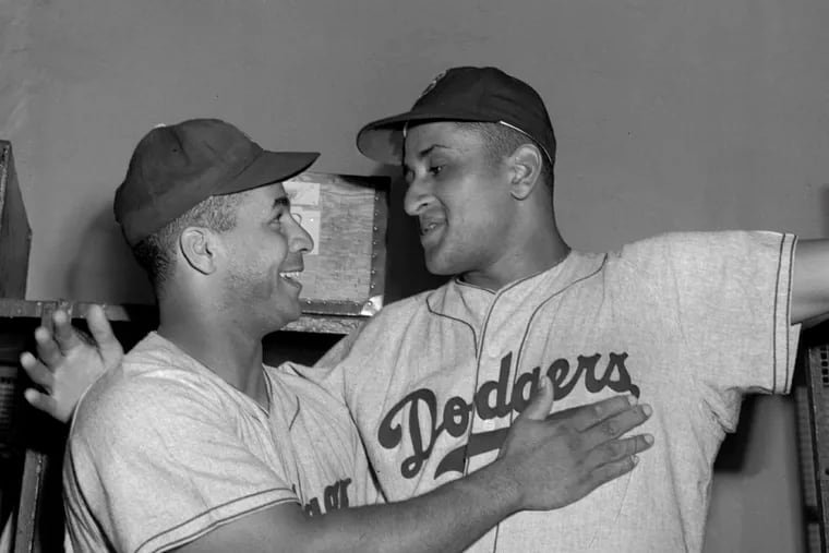 In this September 1949 file photo, Brooklyn Dodgers catcher Roy Campanella (left) congratulates pitcher Don Newcombe after an 8-0 win against the New York Giants, at the Polo Grounds in New York.