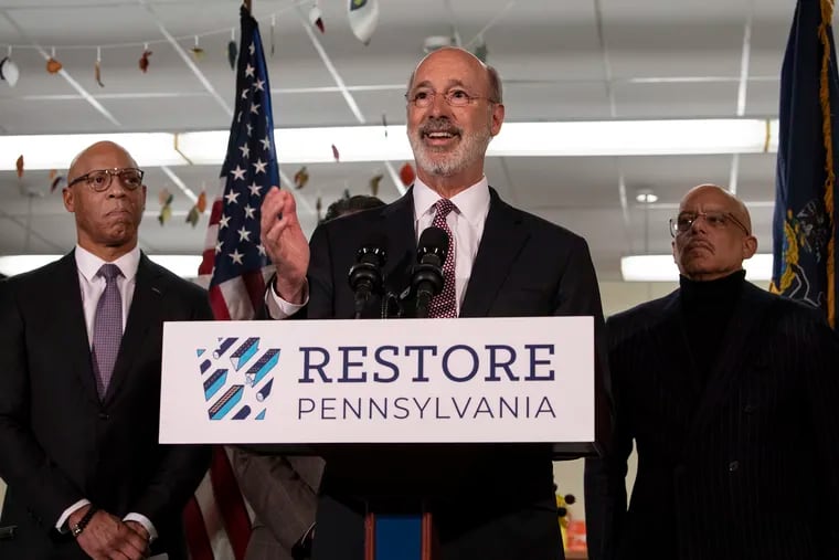 Governor Tom Wolf outlines his plan Thursday to remediate lead from Philadelphia public schools and others throughout the state at the Taggart Elementary in South Philadelphia. He is joined by William R. Hite, superintendent of Philadelphia district schools, and state Sen. Vincent Hughes, right.