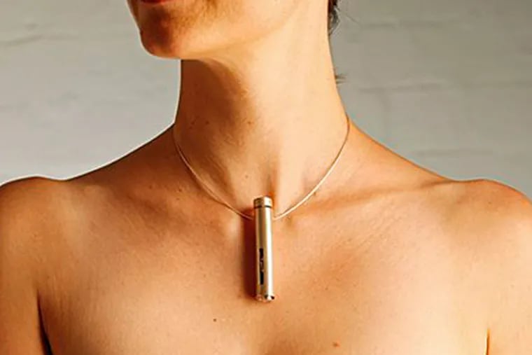 A necklace-ring combo for applying insulin patches for diabetics by designer Leah Heiss is pictured on a model in Melbourne. (AP Photo/David Callow)