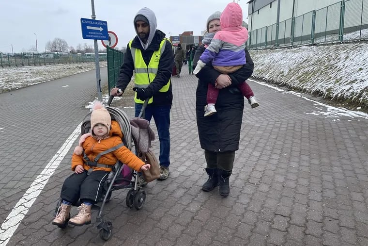 Dharmik Sheth (center) helps Ukrainian refugees make their way along the Poland-Ukraine border. The Temple University graduate and several friends headed to Poland after deciding they needed to help.