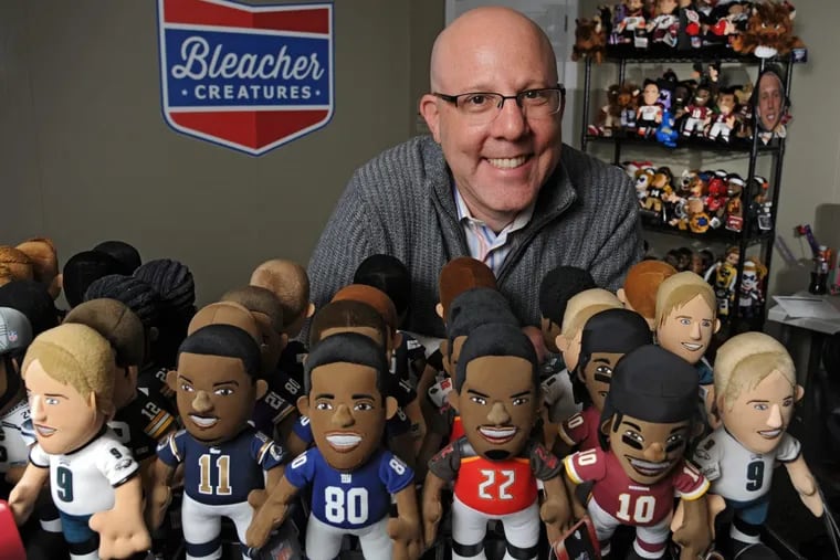 Matthew Hoffman, founder and president of Bleacher Creatures, with some of his creations — stuffed likenesses of professional sports personalities (these are NFL players) in their Plymouth Meeting offices Dec. 1, 2014. ( CLEM MURRAY / Staff Photographer )