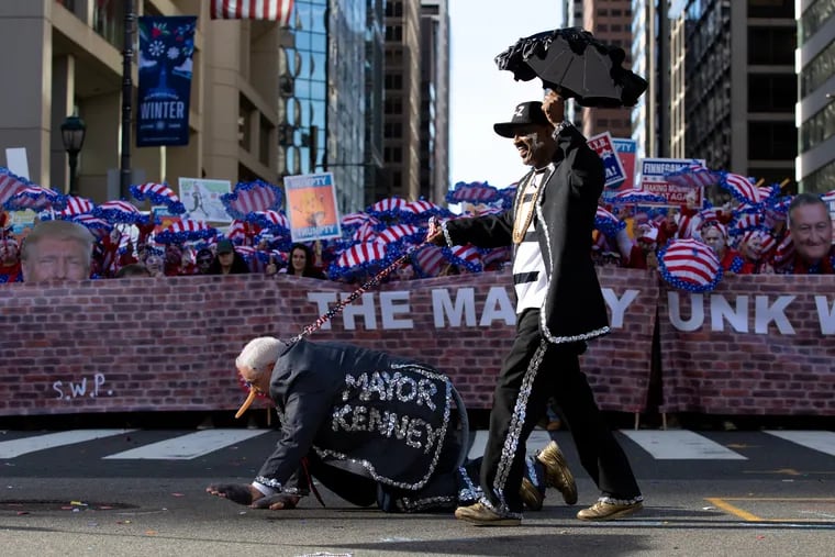 A pair from Finnegan N.Y.B dresses up as Jay-Z walking Mayor Kenney during the Goodtimers Comics division in the Mummers Parade at City Hall in Philadelphia January 1, 2019.