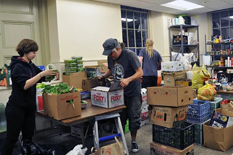 At the Friends center at 15th and Cherry Streets, Sarah Arent and Bryan Lang organize food for the protesters at City Hall. (Gianna Vadino / Staff Photographer)
