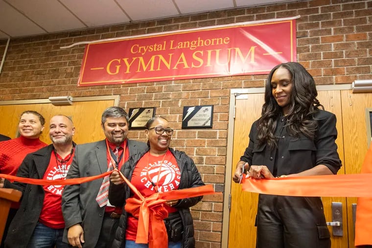 Crystal Langhorne (right) cuts the ribbon to open the renovated gym named in her honor on Wednesday at Willingboro High School. Langhorne, who graduated in 2004, remains the Chimeras' all-time scoring leader and went on to have standout careers at Maryland and in the WNBA.