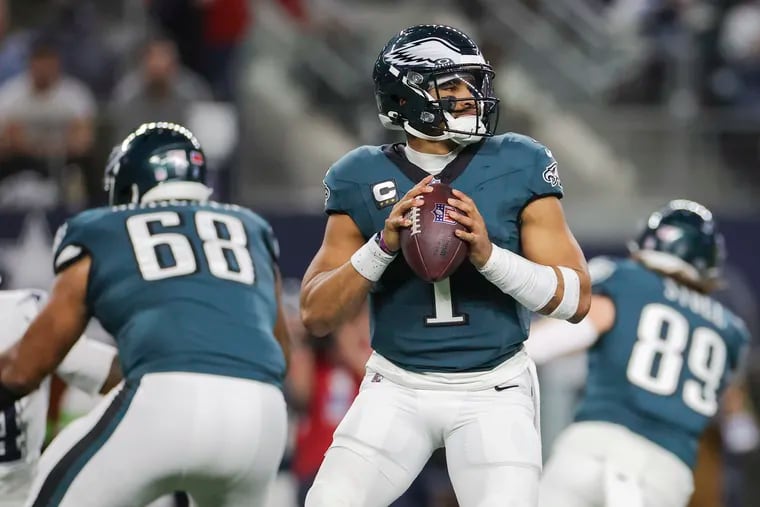 Eagles quarterback Jalen Hurts looks to pass against the  Cowboys on Sunday night. He passed for 197 yards, but the Eagles offense failed to score a touchdown.