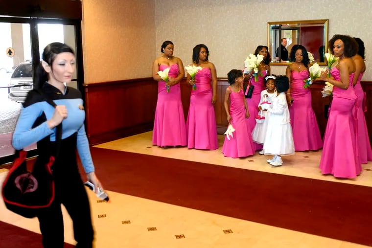 Dressed as a Vulcan character from Star Trek: The Next Generation, Danikat Swizzlestick  of Cherry Hill arrives at the Crowne Plaza Hotel in Cherry Hill May 5, 2012, during weekend-long Official Star Trek Convention. The wedding party was just staying at the hotel. They did not have to share their wedding or reception with the Trekkies. ( TOM GRALISH / Staff Photographer )