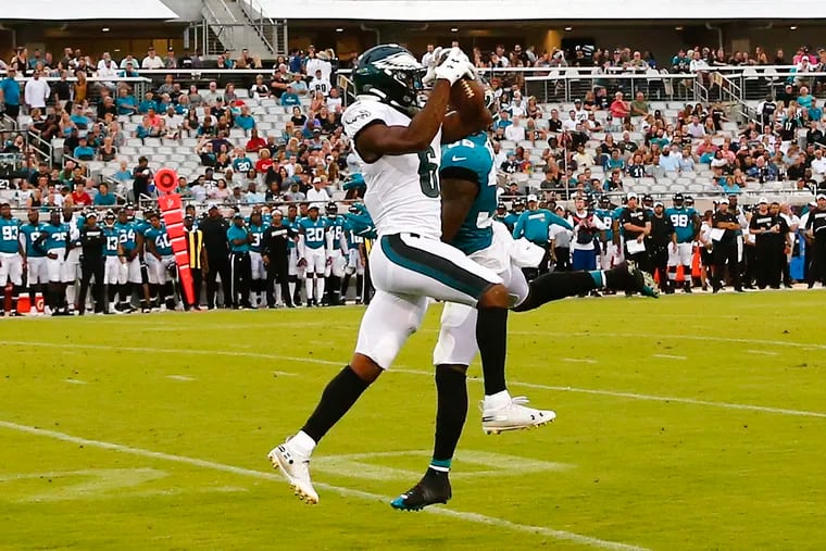 Eagles wide receiver Greg Ward takes the football away from Jaguars safety C.J. Reavis on a second-quarter play Thursday night. Ward scored a 38-yard touchdown on the play.