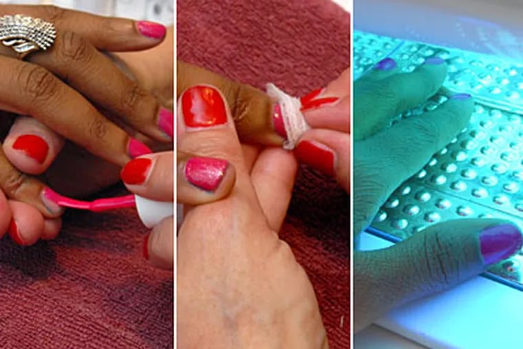 A nail technician at Bernard's Salon & Spa in Cherry Hill uses the Gelish system on a guest, then cures it under ultraviolet light. (April Saul / Staff)