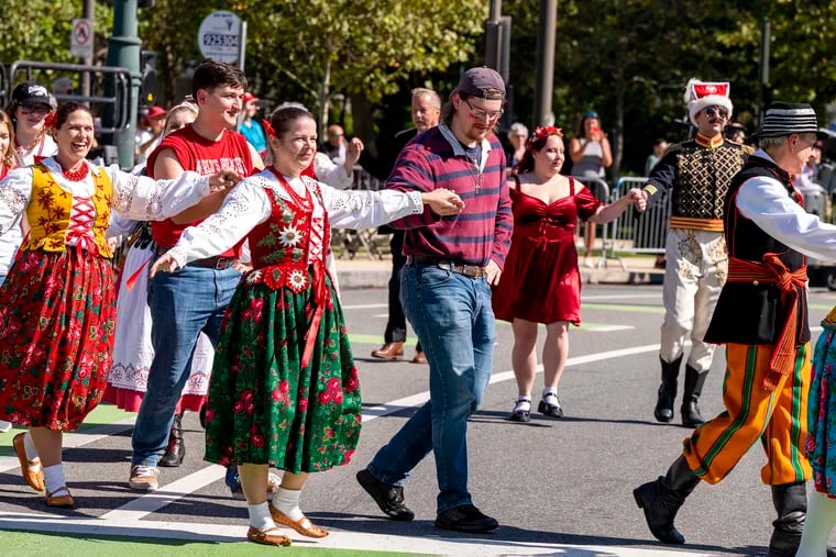 Spectators join participants from different Polish American dance groups for the Polonez, a traditional celebratory folk dance, at the finale the 90th Annual Pulaski Day Parade.