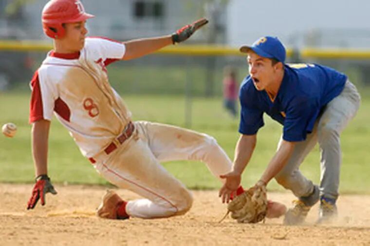 Delsea&#0039;s Eddie Keener slides back to second base on a pickoff attempt as Pennsville shortstop Brett Burdsall takes the throw.