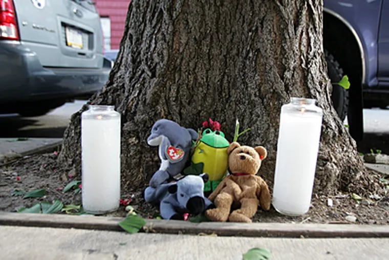 A memorial sits along the sidewalk in the 800 block of Ellsworth Street in South Philadelphia, where Beau Zabel, 23, was gunned down early Sunday morning while walking home from work.