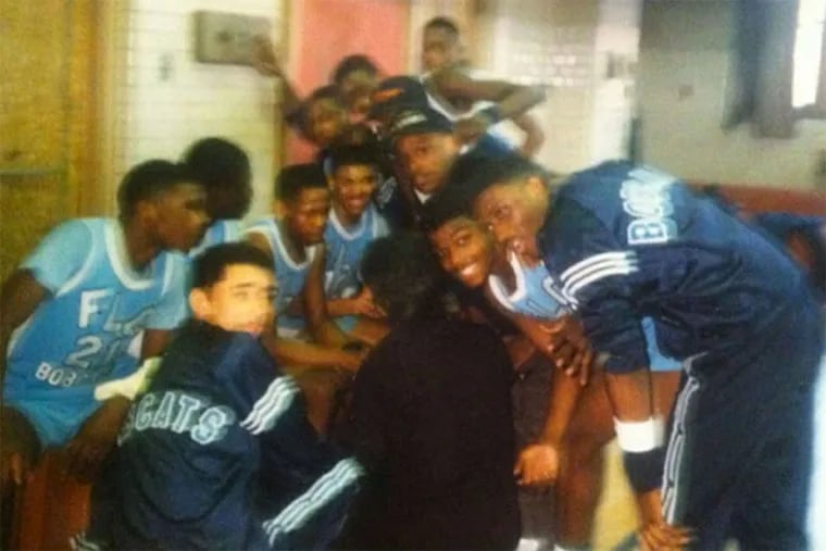 Steve Ashley (far right, bending over with hand on knee) poses with his teammates. Ashley is one of five men who played basketball for Franklin Learning Center that were shot dead between 1994 and 2011.