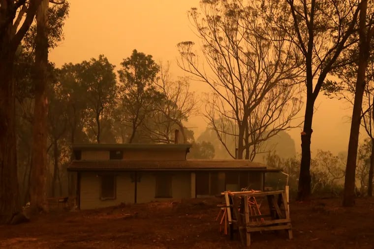 A mud brick house owned by Evan Harris where he is preparing to minimize fire impact at Burragate, Australia,  last Friday as a nearby fire threatens the area.