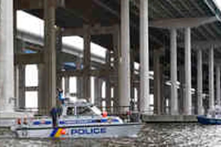 Police boats search the Raritan River under the Driscoll Bridge. The search for the girl is to continue today.