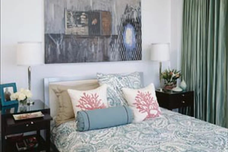 Pablo Soria’s painting sits above a bed for now, mahogany bed side tables. The lamps by Boyd Lighting, coral pillows, and the duvet fabric is by Groundworks.