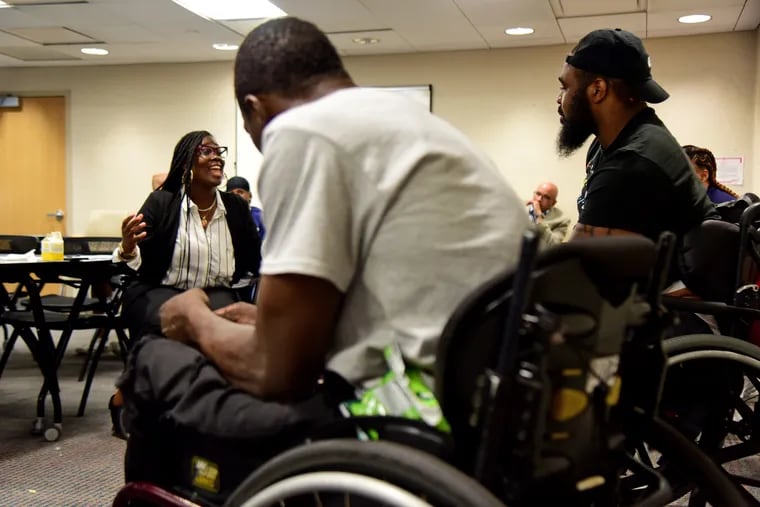 Victoria Wylie (left), whose brother was gunned down in 2008, joins in the discussion with Jalil Frazier (right) and John Muldrow (center), as paralyzed gunshot survivors get together for the first time to talk about creating a support group at Temple University Hospital. Frazier is part of an online community but came up with the idea of an fellowship of survivors to meet others in person.