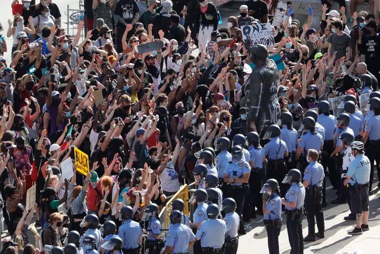 Protesters and police at the Rizzo statue in front of the Municipal Services Building in Philadelphia during a "Justice for George Floyd" protest on Saturday, May 30, 2020.