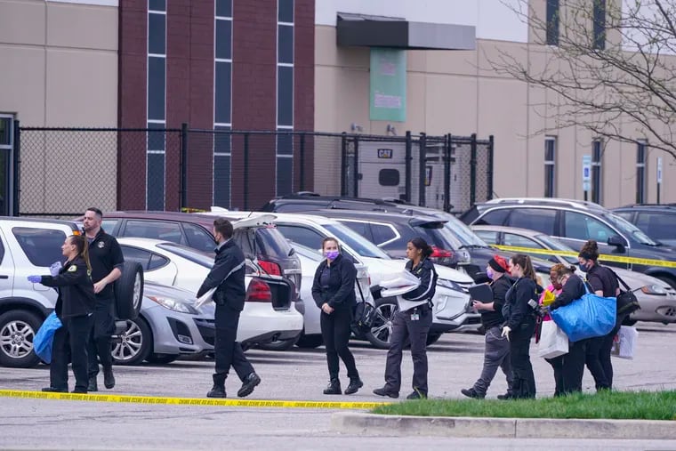 Law enforcement confer at the scene in Indianapolis, where multiple people were shot at a FedEx Ground facility near the Indianapolis airport.