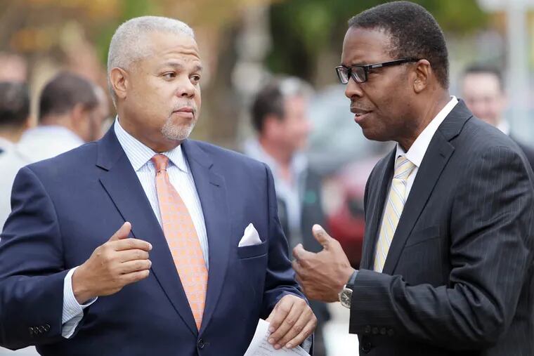 State Sen. Anthony Hardy Williams, left, and council president Darrell Clarke, right, talk outside Famous 4th Street Deli on Election Day in Philadelphia on November 4, 2014. ( DAVID MAIALETTI / Staff Photographer )