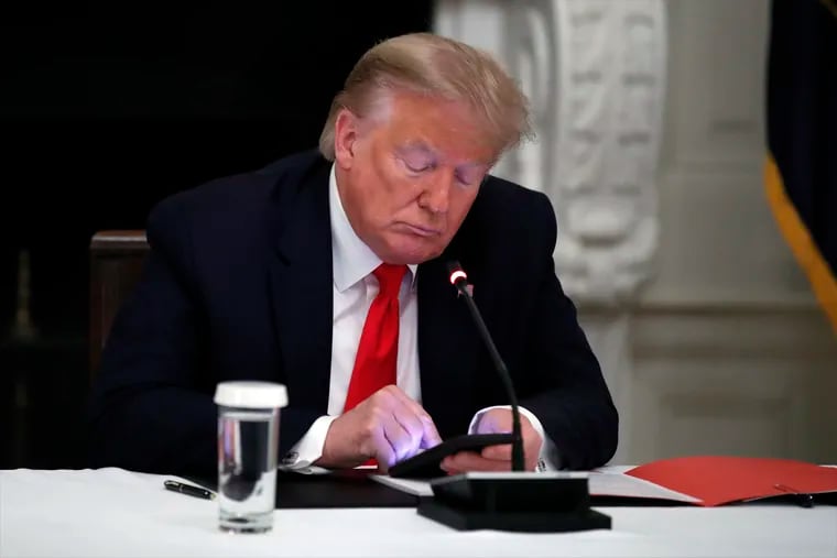 President Donald Trump looking at his phone during an event last June.