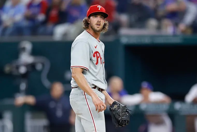 Phillies pitcher Aaron Nola looks up after before getting replaced during the fourth inning against the Texas Rangers at Globe Life Field in Arlington, Texas on Thursday, March 30, 2023.