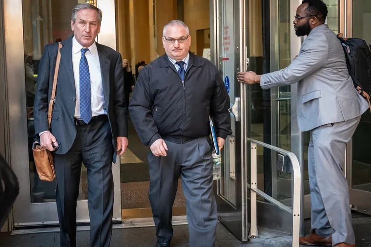 Former Philadelphia homicide detective Philip Nordo (center) and lawyer Michael van der Veen exit the Criminal Justice Center in Philadelphia in May.