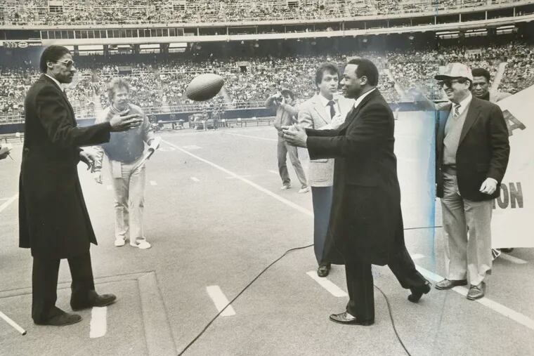 Dr. J tosses the ball to Mayor W. Wilson Goode in 1984 at Veterans Stadium, where Goode wanted the 1987 Super Bowl. He came close.