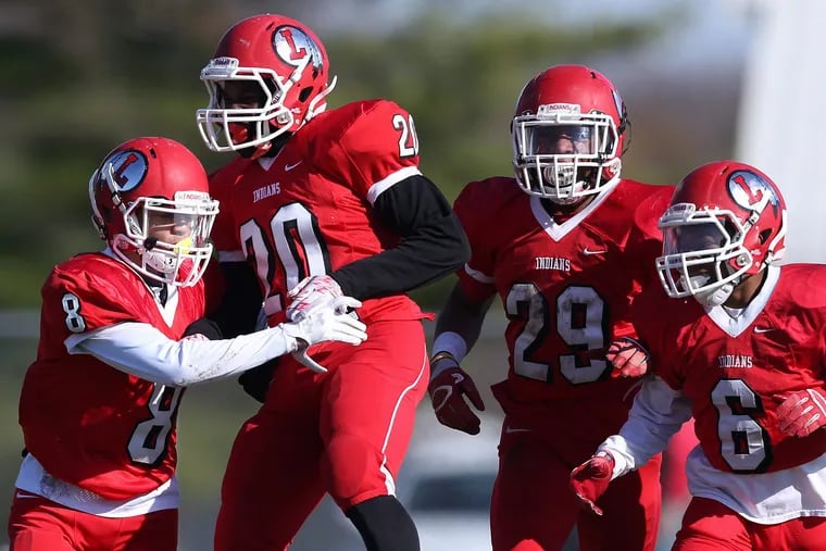 Lenape's Amir Byrd (8) celebrates a third-quarter touchdown with Brandon Carter (20), Dasan Craig (29) and Legend King (6) during the annual Thanksgiving day game against Shawnee at Lenape High School in Medford, New Jersey, on Thursday, Nov. 23, 2017. Lenape won 45-0.