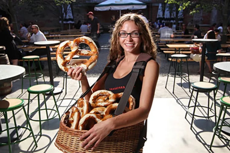 Pretzel girl Katie Roberts with real German pretzels at Frankford Hall. (Michael Bryant / Staff photographer)