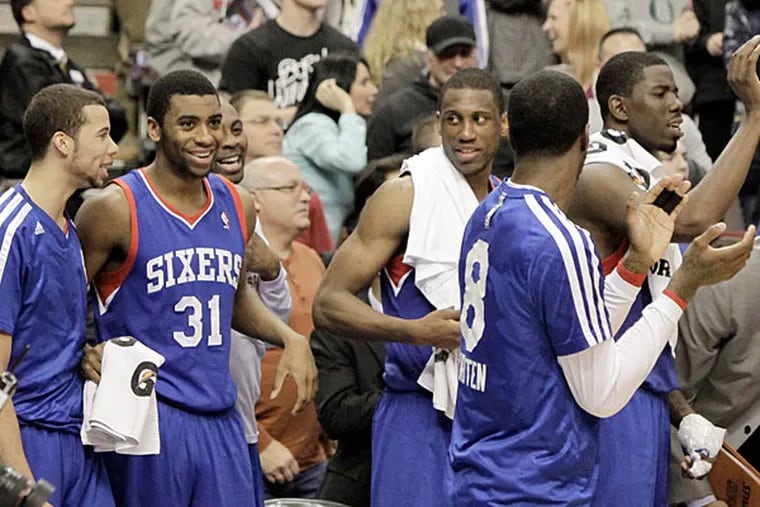Sixers players cheer at the end of the Pistons game. (Elizabeth Robertson/Staff Photographer)