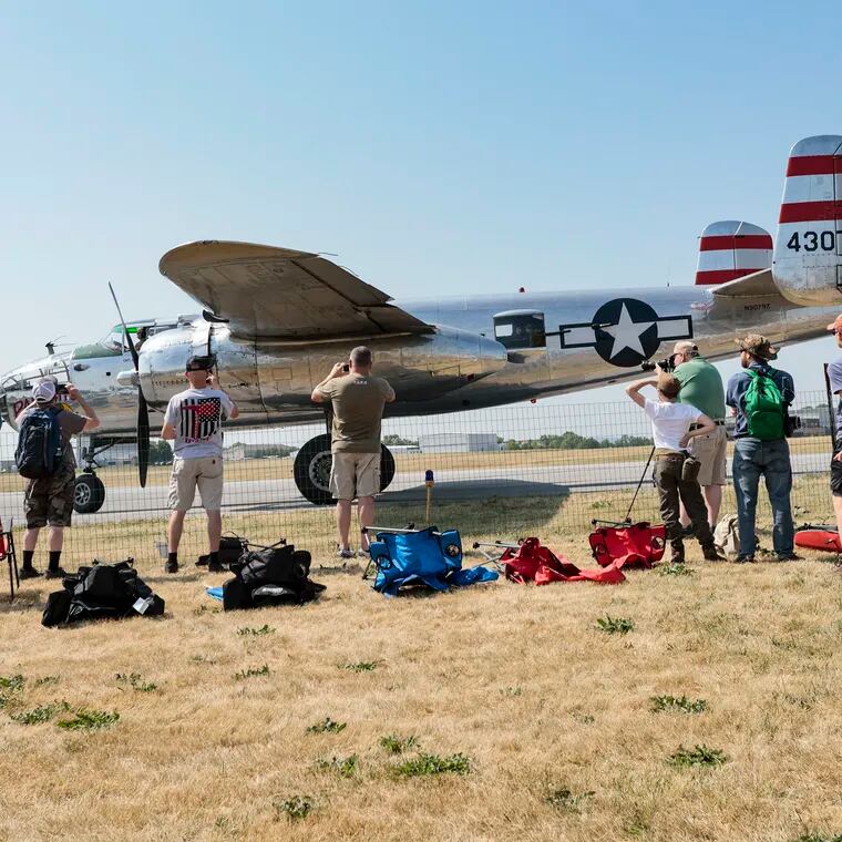 People watch a s a B-25 rolls by at the 32nd Annual WWII Weekend at the Reading Regional Airport,  Friday. June 2, 2023 