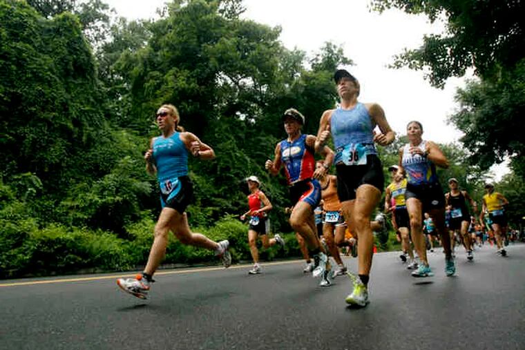 Creating their own thunder, one of the first waves of competitors in the Danskin Women's Triathlon sets off in Fairmount Park. Due to storms, the Schuylkill-swim leg was replaced with another run.