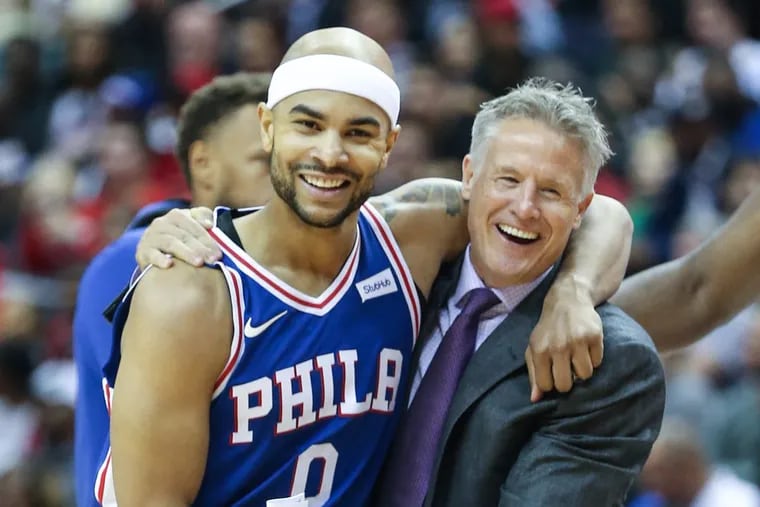 Sixers coach Brett Brown hugs Jerryd Bayless after the guard hit a three-pointer against the Wizards.