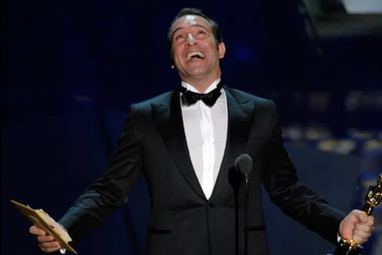 Jean Dujardin accepts the Oscar for best actor in a leading role for “The Artist” during the 84th Academy Awards on Sunday, Feb. 26, 2012, in the Hollywood section of Los Angeles. (AP Photo/Mark J. Terrill)