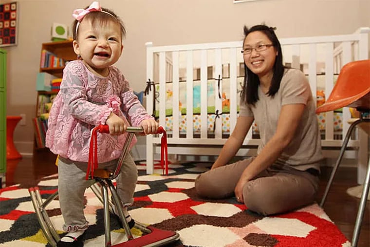 Chulatip Katson watches 8-month-old Alyssa rock out on her 1950s rocker/scooter. Katson has gone all-in for vintage furnishings in the baby's room. (Michael Bryant/Staff Photographer)