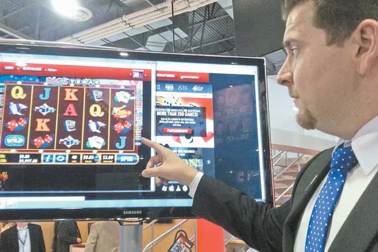 Bally Technologies, Inc.'s Mike McKiski, an interactive sales manager, shows off the company's i-Gaming platform at this week's Global Gaming Conference in Las Vegas. He is playing a slots game called Big Vegas on a website. The game is available on casino floors.  (Photo by Suzette Parmley)