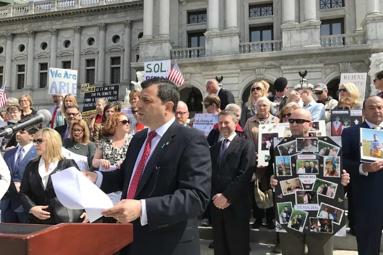 Rep. Mark Rozzi (D., Berks) leads a child sex-abuse legislation rally at the Pennsylvania Capitol on Monday-. Behind him are three dozen fellow childhood sexual abuse victims and advocates.