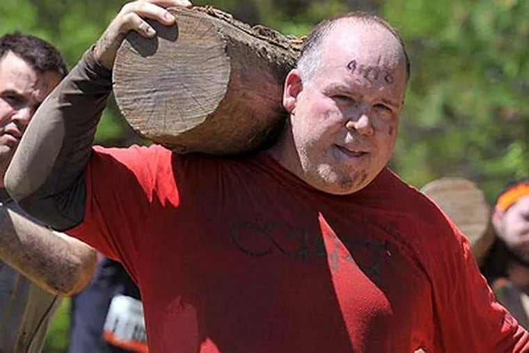 Chris Brennan is not just a tough, hard-nosed reporter. He's one "Tough Mudder," and he's showing it here during the popular endurance event as he shoulders a log.