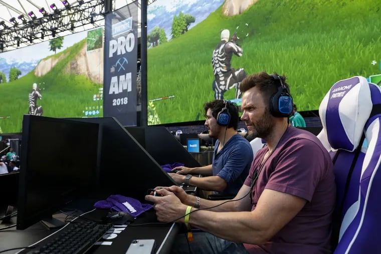 Actor Joel McHale (right) plays in the Fortnite Battle Royale Celebrity Pro-Am on the sidelines of the E3 expo in Los Angeles on June 12.